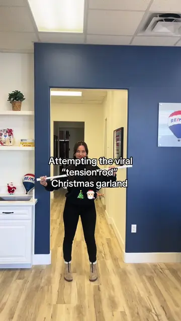 Our attempt at the tension rod/curtain rod Christmas garland for the office 🎄🎅