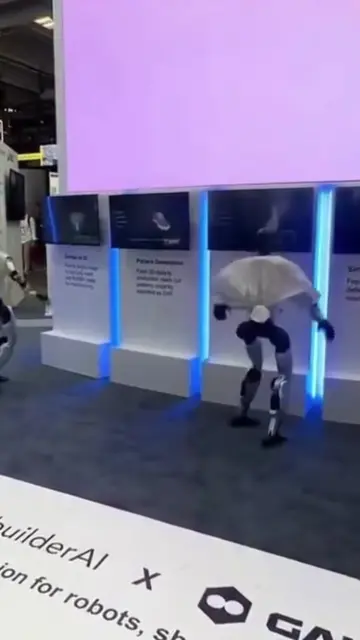 Two Unitree humanoids were mid-synchronized routine at the RebuilderAI booth in 