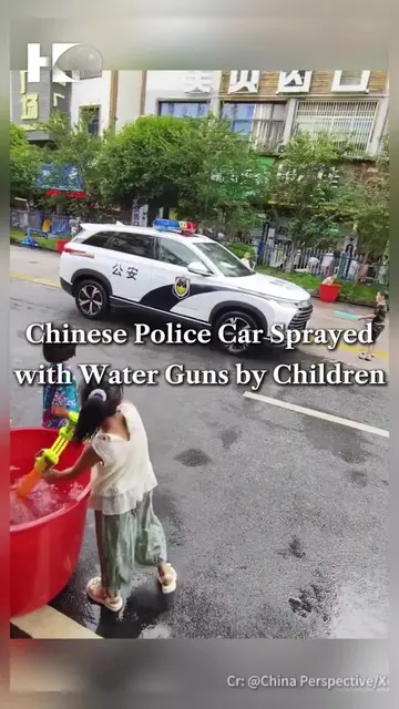 A video shared on social media shows children playing with water guns on a stree