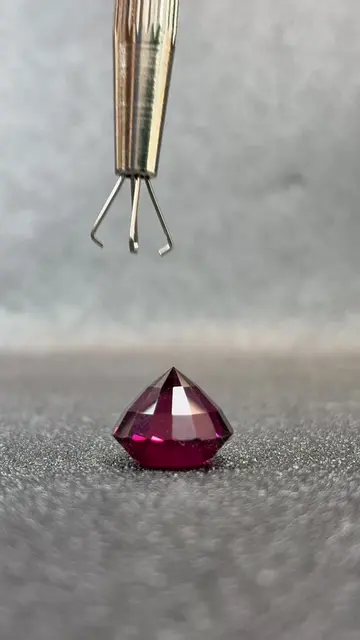This is a 10 carat Red Garnet, precision-cut into a perfect round that throws fi