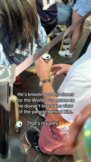 He’s kneeling on his shoes for the World Cup game so he doesn’t block the view o