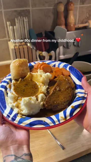 Smothered Pork Chops with homemade onion gravy, creamy mashed potatoes, carrots,