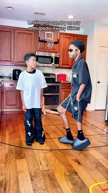 Letting my son try on my orthopedic Yeezy Slides 🦩🔥 #fyp #foryoupage #yeezy #a