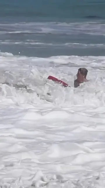 Video shows the moment a little boy was rescued after he was swept out to sea by
