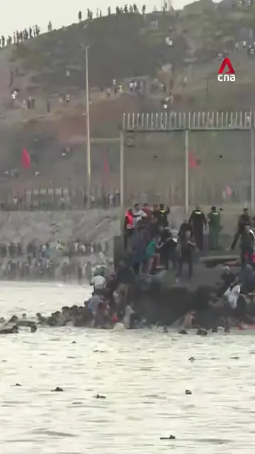 Hundreds of migrants have crossed from Morocco into Spain's North African enclav