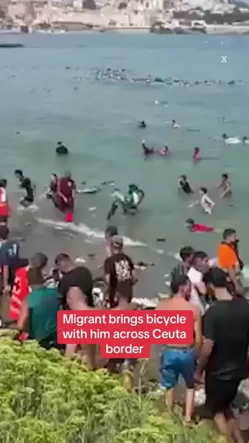 A man was spotted carrying a bicycle across the Spanish border as a wave of thou