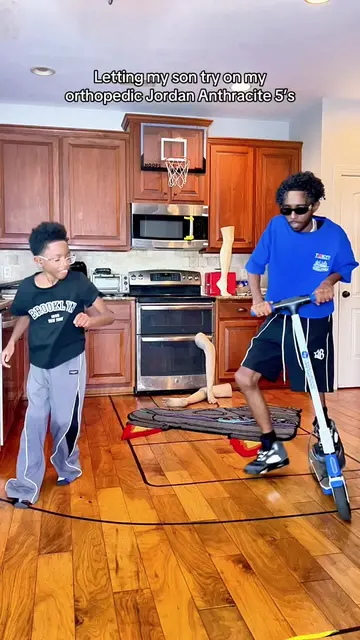 Letting my son try on my orthopedic Jordan Anthracite 5’s 🦩🔥 #fyp #foryoupage 