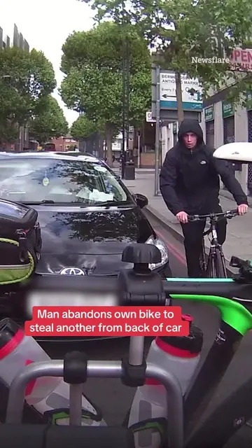 This is the moment a brazen thief abandons his own bike to steal another from th
