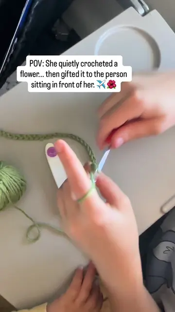 She spent her flight time crocheting a flower car mirror charm for the person si