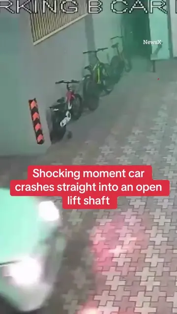 This is the shocking moment a driver crashes straight into an open lift shaft an
