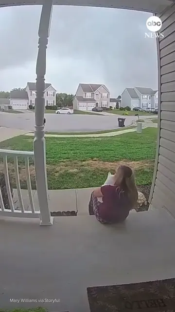 A lightning strike scared the daylights out of a woman and her cat as they watch