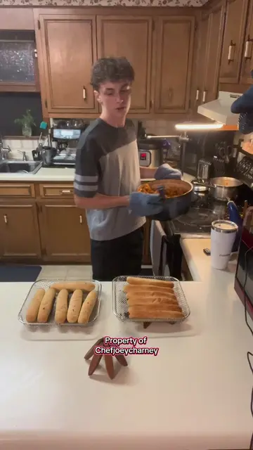 Cooking dinner for my family: Chicken marinara pasta with garlic breadsticks.  (
