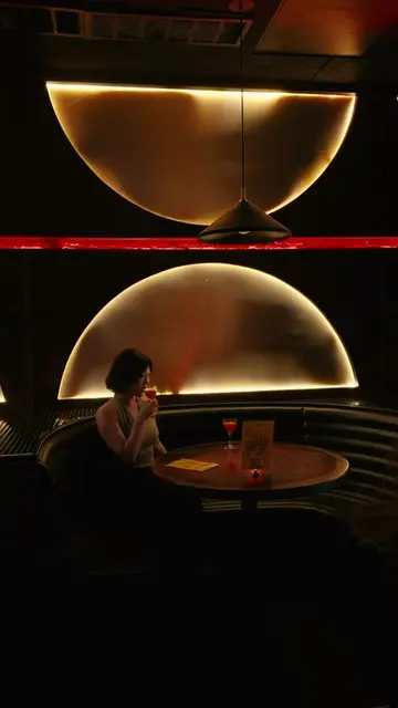 Visitor visits Ask For Janice, a small yet vibrant speakeasy-style bar hidden be