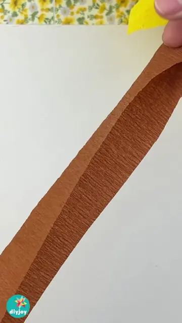 This easy fall craft idea turns simple crepe paper into a beautiful sunflower yo