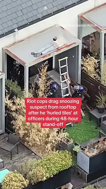 This is the moment riot cops dragged a snoozing suspect from a rooftop following