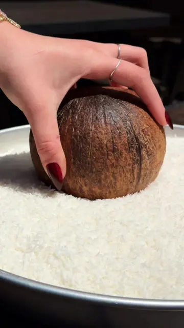 Coconut heaven in a shell! 🥥✨ Creamy coconut ice cream with your choice of rich