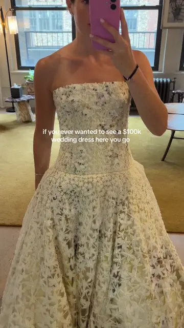 A museum worthy wedding dress with hand painted watercolors, real pearls, and th