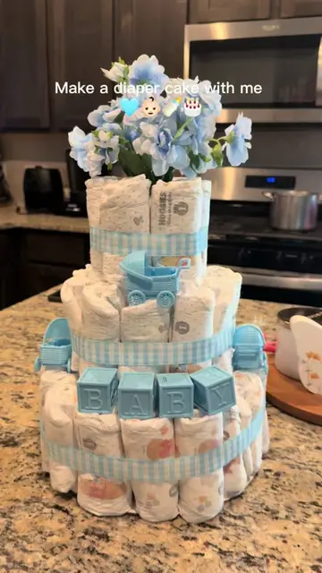 Not bad for my first diaper cake, loved how it came out and so easy ! 🥹🩵🍼✨ . 