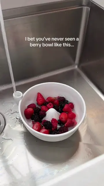 No hands needed to spin your berries with this pretty ceramic strainer with a wa