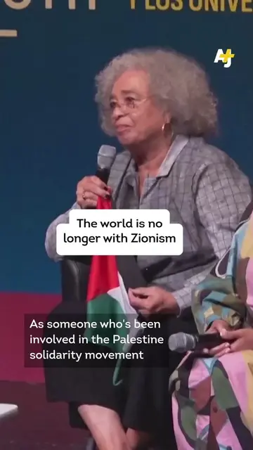Political activist and author Angela Davis held up a Palestinian flag given to h