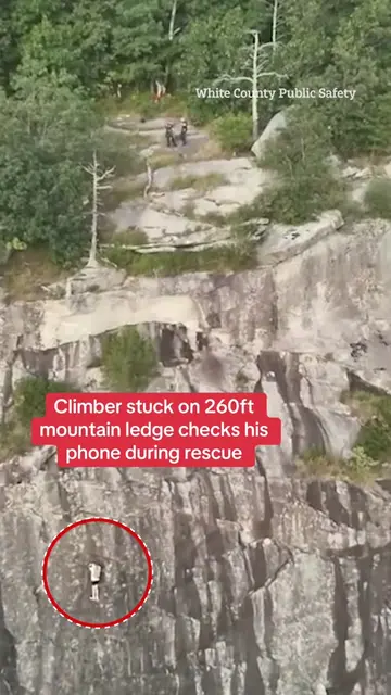 This is the shocking moment a climber foolishly pulls out their phone while stra