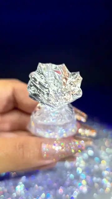 A tiny pouch keychain with floating crystal pieces inside. Made with UV resin an