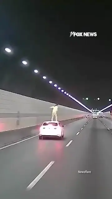 Dashcam video captures the heart-stopping moment a woman jumps from the roof of 