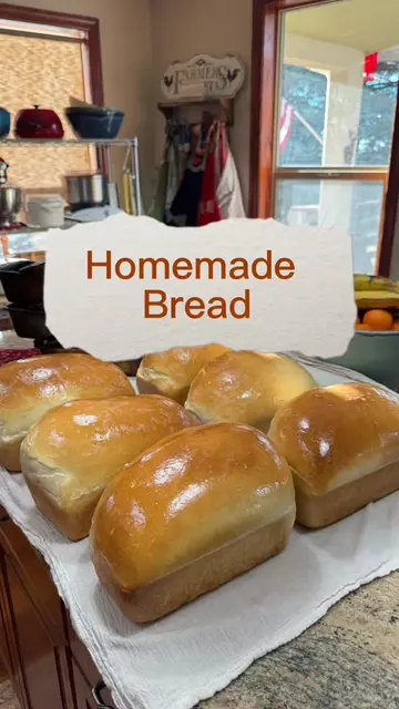 Recipe Below! ⬇️ Pulling the loaves of bread out of the oven, buttering the hot 