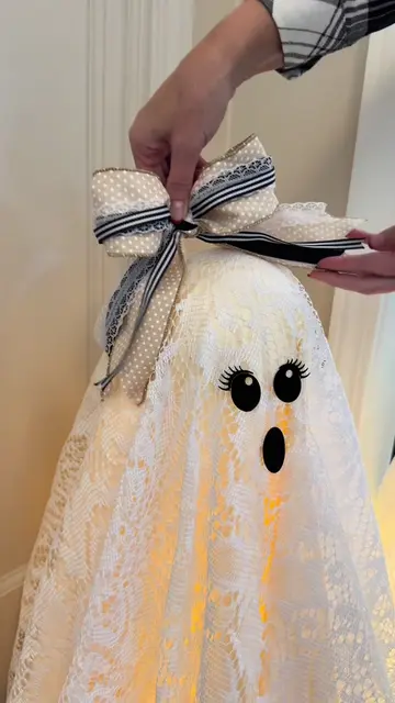 Two tomato cages, two Styrofoam heads, a lace tablecloth, and one lace skirt fro