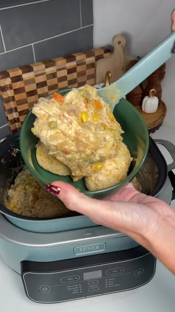 Crockpot chicken pot pie over warm cheddar bay biscuits for an easy after practi