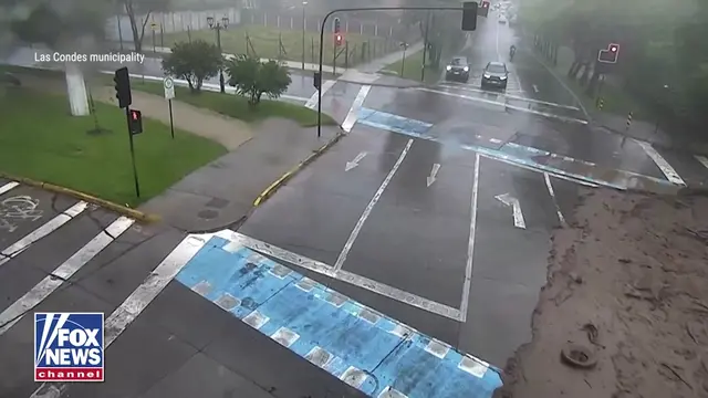 WATCH: Cars are swept away, drivers lose control, and one man desperately clings