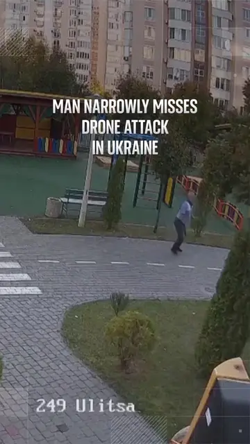 CCTV footage captured the moment an alleged drone narrowly misses a man walking 