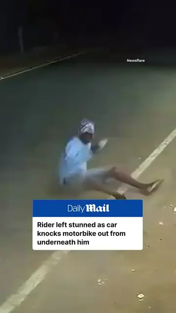 A motorbike rider was knocked to the ground after a car suddenly veered into his
